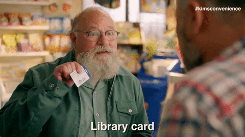 Gif of an older man at a convenience store holding up a Toronto Public Library card.