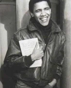 Photo of a young Barack Obama holding a book.