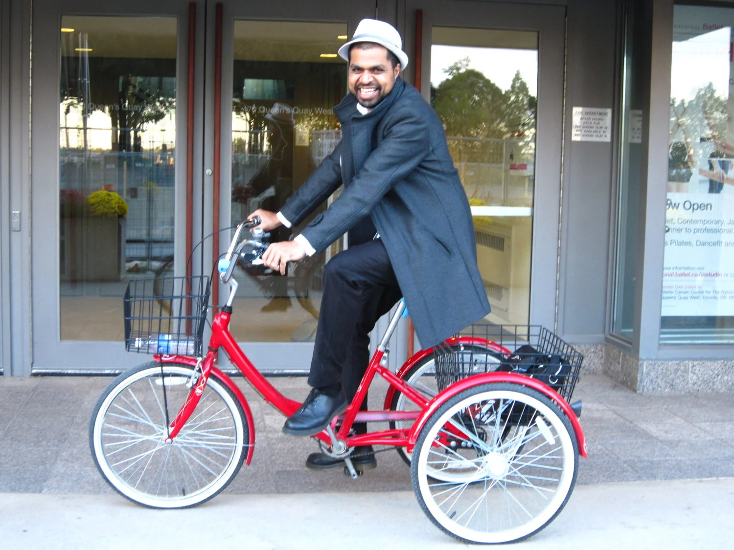 Rahim Ladha on a gigantic red tricycle in front of the Walter Carsen Centre/National Ballet of Canada (Photo: Sabrina Ayton) 