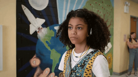 A girl with an expression of wonder while listening to something in a pair of headphones