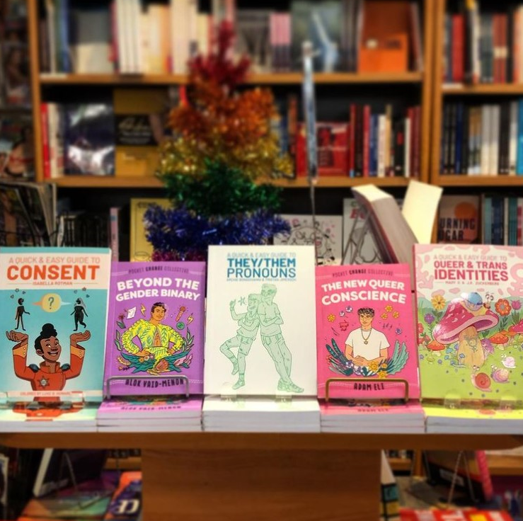 A display of colourful books on a table. 